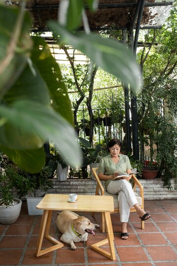Woman Enjoying a Book in a Garden with Her Dog